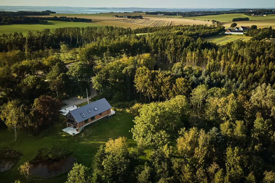 Sommerlicht legt sich über Stahlprofile im Wald, Klæstruplundvej 11, 9240 Nibe, Dänemark